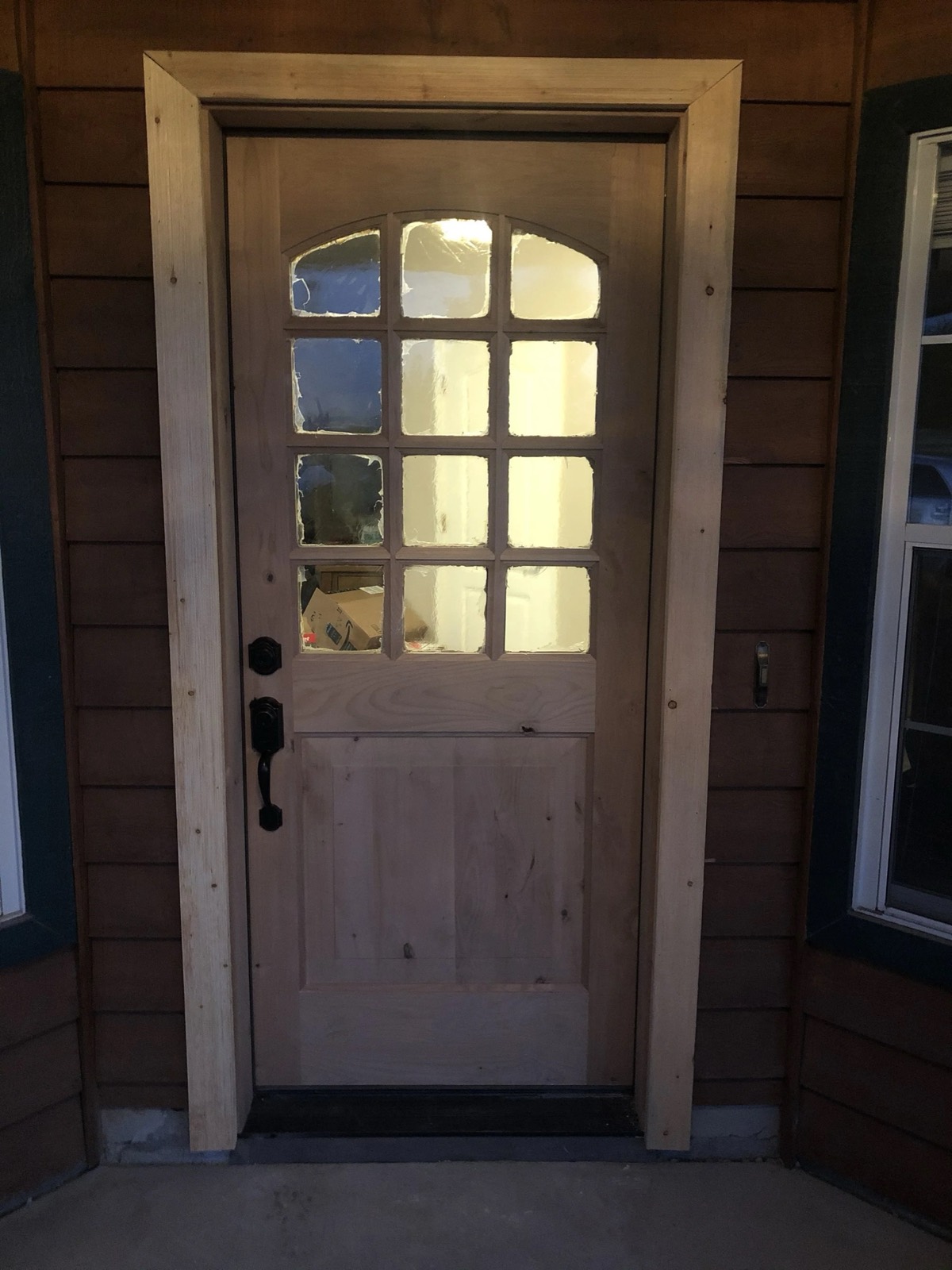 A craftsman entry door with divided lights, installed by Redeemed Builders